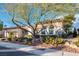 Inviting single-story home with desert landscaping, rock features, and mature tree, offering curb appeal at 10534 Mandarino Ave, Las Vegas, NV 89135