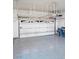 Spacious garage featuring epoxy floors and overhead storage racks at 10534 Mandarino Ave, Las Vegas, NV 89135