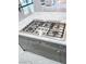 Modern kitchen with a cooktop on a central island, perfect for preparing gourmet meals at 10534 Mandarino Ave, Las Vegas, NV 89135