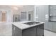 Modern kitchen with stainless steel appliances, sleek cabinetry, and a central island perfect for cooking at 10534 Mandarino Ave, Las Vegas, NV 89135