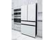 A modern kitchen featuring stainless steel appliances and sleek white cabinetry at 10534 Mandarino Ave, Las Vegas, NV 89135