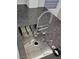 Gourmet kitchen sink features modern fixtures, including a professional-style faucet and granite countertops at 10534 Mandarino Ave, Las Vegas, NV 89135