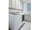 Modern laundry room boasts new washer, dryer and a sink with marble countertop at 10534 Mandarino Ave, Las Vegas, NV 89135