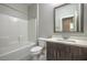 Clean bathroom with combined tub and shower, toilet, and modern vanity at 1056 Via Panfilo Ave, Henderson, NV 89011