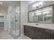 Stylish bathroom featuring large mirror, modern vanity, and glass enclosed shower at 1056 Via Panfilo Ave, Henderson, NV 89011