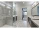 Modern bathroom featuring a glass enclosed shower and a double sink vanity at 1056 Via Panfilo Ave, Henderson, NV 89011
