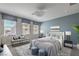This virtually staged bedroom boasts three windows and an accent wall at 1056 Via Panfilo Ave, Henderson, NV 89011