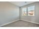 Neutral bedroom with carpet flooring and two windows providing natural light at 1056 Via Panfilo Ave, Henderson, NV 89011