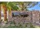 A stone community sign with lush landscaping and flowering bushes at 1056 Via Panfilo Ave, Henderson, NV 89011