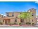 Beautiful multi-story condo featuring manicured shrubs, desert landscaping, and a red tile roof at 1056 Via Panfilo Ave, Henderson, NV 89011