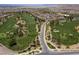 Scenic aerial shot of a lush, green golf course winding through a beautiful residential community at 1056 Via Panfilo Ave, Henderson, NV 89011
