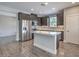 Modern kitchen with stainless steel appliances, island, stylish cabinets and mosaic backsplash at 1056 Via Panfilo Ave, Henderson, NV 89011