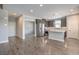 Spacious open-concept kitchen featuring stainless steel appliances and a large island with breakfast bar seating at 1056 Via Panfilo Ave, Henderson, NV 89011