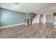 Spacious living room with modern finishes, hardwood floors, and open staircase, perfect for entertaining at 1056 Via Panfilo Ave, Henderson, NV 89011