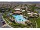 Overhead view of a resort-style pool with palm trees, cabanas, and lounge chairs in a well-kept community at 1056 Via Panfilo Ave, Henderson, NV 89011