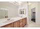 Bathroom with dual sinks and tiled floors and shower enclosure at 10800 Amber Ridge Dr # 103, Las Vegas, NV 89144