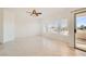 Bright bedroom with a ceiling fan, and a sliding glass door to a balcony with neighborhood views at 10800 Amber Ridge Dr # 103, Las Vegas, NV 89144