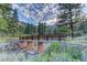 Picturesque stone bridge over a stream surrounded by trees and vegetation at 10800 Amber Ridge Dr # 103, Las Vegas, NV 89144