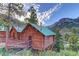 Charming log cabins with green roofs nestled against a mountain landscape at 10800 Amber Ridge Dr # 103, Las Vegas, NV 89144
