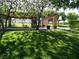 Scenic view of community park with covered picnic tables, BBQ and lush green lawn at 10800 Amber Ridge Dr # 103, Las Vegas, NV 89144
