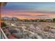 Relaxing view of a walkway and desert landscaping with homes in the distance at 10800 Amber Ridge Dr # 103, Las Vegas, NV 89144