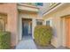 Close up view of the front door of this lovely condo featuring professionally maintained landscaping at 10800 Amber Ridge Dr # 103, Las Vegas, NV 89144