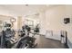 Well-equipped fitness center with treadmills, ellipticals, bikes, mirrored wall and mounted TV at 10800 Amber Ridge Dr # 103, Las Vegas, NV 89144