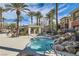 Community hot tub and seating area with mature landscaping and palm trees at 10800 Amber Ridge Dr # 103, Las Vegas, NV 89144