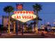 Iconic 'Welcome to Las Vegas' sign surrounded by palm trees at dusk at 10800 Amber Ridge Dr # 103, Las Vegas, NV 89144