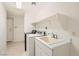 Bright laundry area features a utility sink, storage, and modern washer and dryer at 10800 Amber Ridge Dr # 103, Las Vegas, NV 89144