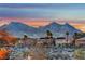 Scenic view of mountains, desert landscape, and neighborhood homes at dusk at 10800 Amber Ridge Dr # 103, Las Vegas, NV 89144