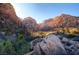 Stunning mountain vista with lush vegetation and rock formations under a bright sky at 10800 Amber Ridge Dr # 103, Las Vegas, NV 89144