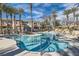 Inviting community pool with surrounding palm trees and condos on a sunny day at 10800 Amber Ridge Dr # 103, Las Vegas, NV 89144