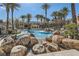 Resort-style pool area featuring mature palm trees and inviting leisure amenities at 10800 Amber Ridge Dr # 103, Las Vegas, NV 89144