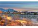 Attractive neighborhood street featuring desert landscaping with mountain views at dusk at 10800 Amber Ridge Dr # 103, Las Vegas, NV 89144