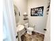 Charming powder room featuring pedestal sink, modern fixtures, and decorative wall art at 10819 Far Country Ave, Las Vegas, NV 89129