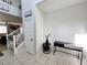 Bright entryway with tiled floors, staircase, and console table at 10819 Far Country Ave, Las Vegas, NV 89129