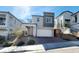 Modern two-story home with neutral color scheme, brick driveway, and manicured landscaping at 10819 Far Country Ave, Las Vegas, NV 89129