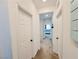 Hallway with neutral color and multiple doors leading to various rooms in the house at 10819 Far Country Ave, Las Vegas, NV 89129