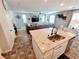 Modern kitchen island with a stainless steel sink overlooking the living room at 10819 Far Country Ave, Las Vegas, NV 89129