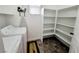 Clean laundry room featuring modern appliances, open storage and tile flooring at 10819 Far Country Ave, Las Vegas, NV 89129