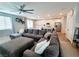 Open-concept living space with a large sectional sofa adjacent to a modern kitchen and dining area at 10819 Far Country Ave, Las Vegas, NV 89129