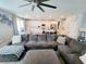 Comfortable living room with a large sectional sofa open to a modern kitchen at 10819 Far Country Ave, Las Vegas, NV 89129