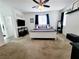Spacious main bedroom with neutral colored carpet, ceiling fan and modern furnishings at 10819 Far Country Ave, Las Vegas, NV 89129