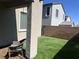 Beautiful covered patio with outdoor seating, brick pavers and artificial turf lawn at 10819 Far Country Ave, Las Vegas, NV 89129