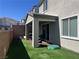 Backyard patio area with brick wall, and an artificial turf lawn at 10819 Far Country Ave, Las Vegas, NV 89129