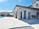 Exterior view of pool restrooms, featuring stone accents, an outdoor shower, and a nearby pergola at 10819 Far Country Ave, Las Vegas, NV 89129