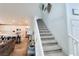 Open staircase connecting the living area to the upper level with decorative wall art at 10819 Far Country Ave, Las Vegas, NV 89129