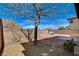 Spacious backyard with a tree, gravel, brick-lined patio, and mountain views in the distance at 112 Austin Rose Ave, Henderson, NV 89002