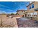 This backyard features a brick-lined patio, seating, and mountain views beyond the block wall at 112 Austin Rose Ave, Henderson, NV 89002